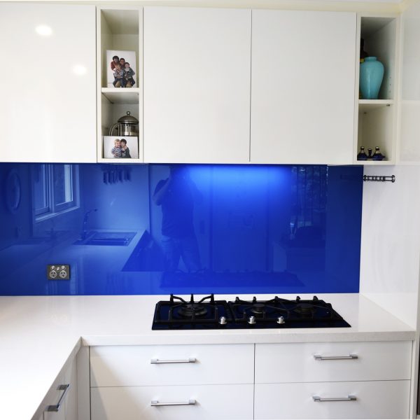 white kitchen with blue coloured glass splashback