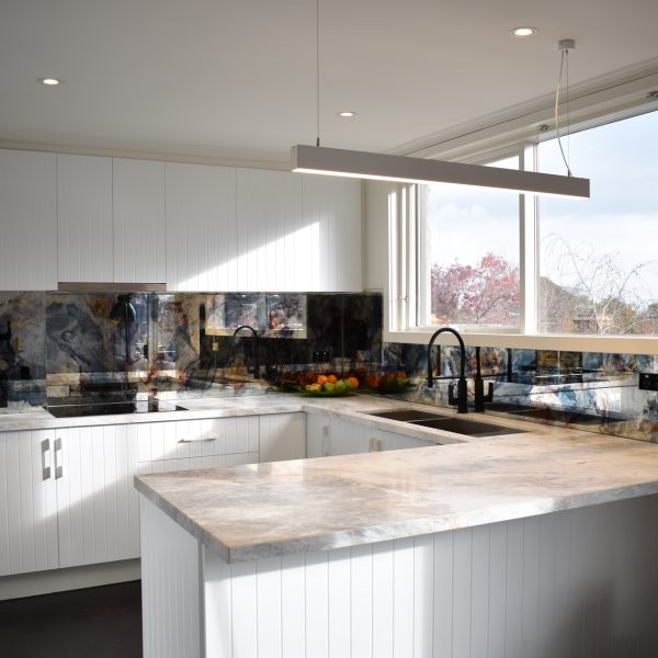 modern white kitchen with distressed mirror splashback