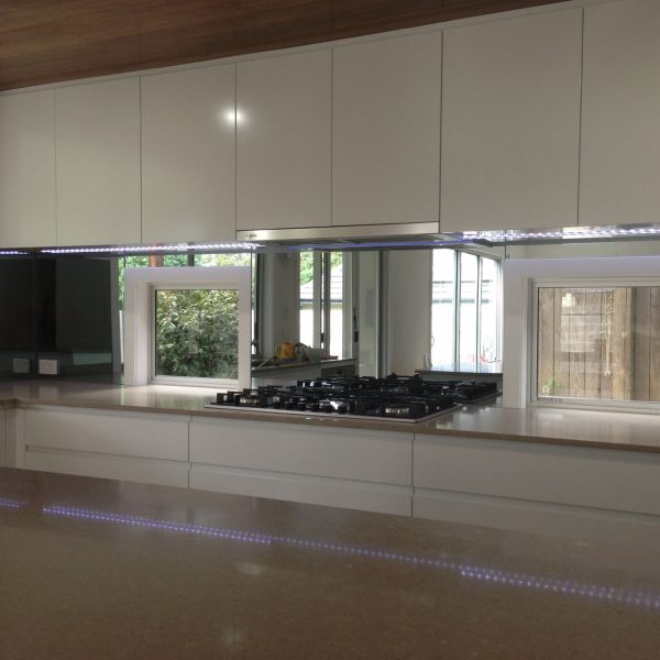 modern kitchen with mirror stove splashback