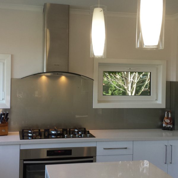 olive grey coloured glass splashback in white kitchen