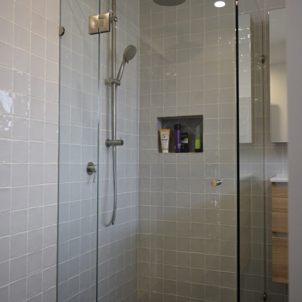 frameless shower screen in light grey bathroom