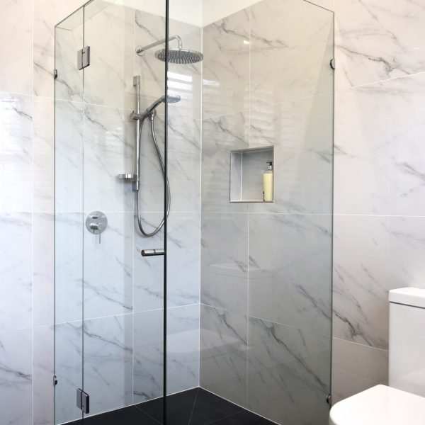 frameless shower screen in white bathroom