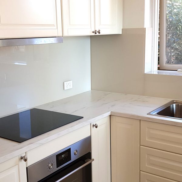 neutral tone kitchen with grey glass splashback