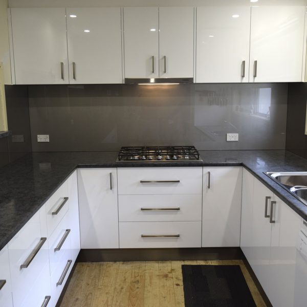 modern grey glass splashback in white kitchen
